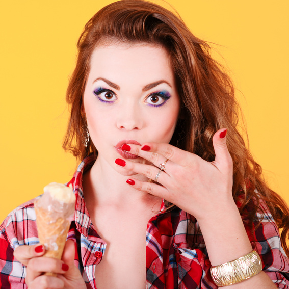 A pretty woman eating ice cream at her sweet event. Join the fun on buddypassgo.com! 